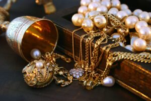 Jewellery laying over an indian jewellery box.See similar pictures: Jewelry: